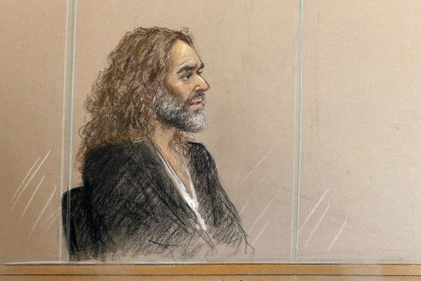 A sketch of a man with long hair, sitting and looking on.