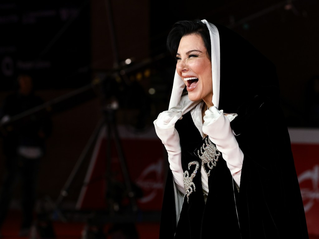 Kris Jenner smiling and laughing while attending the premiere.