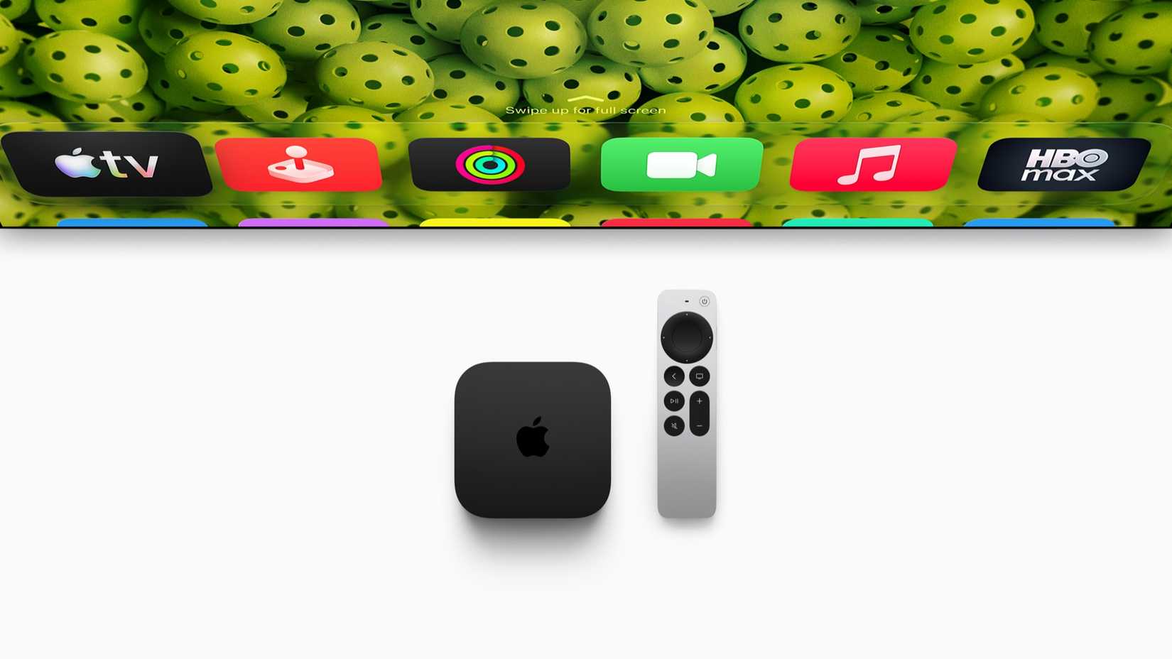 Apple TV 4K streaming box and Siri Remote displayed beneath a television interface featuring Apple TV, Music, FaceTime, and HBO Max apps.