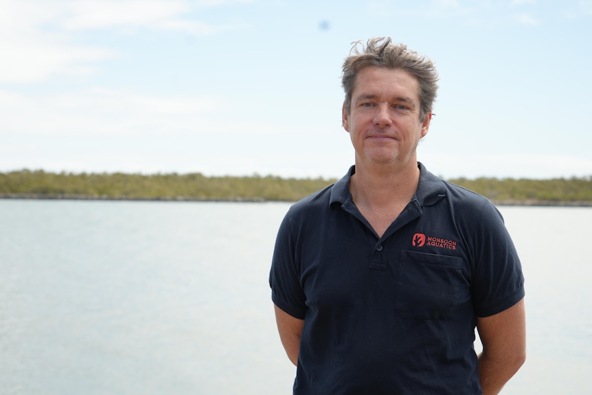 a man in front of a waterfront