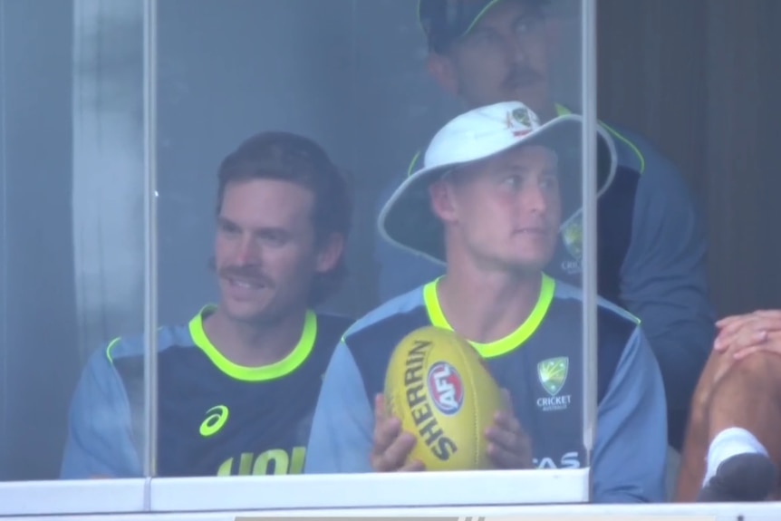Noah Anderson (left) sits in the Australian cricket rooms during a Test against South Africa.