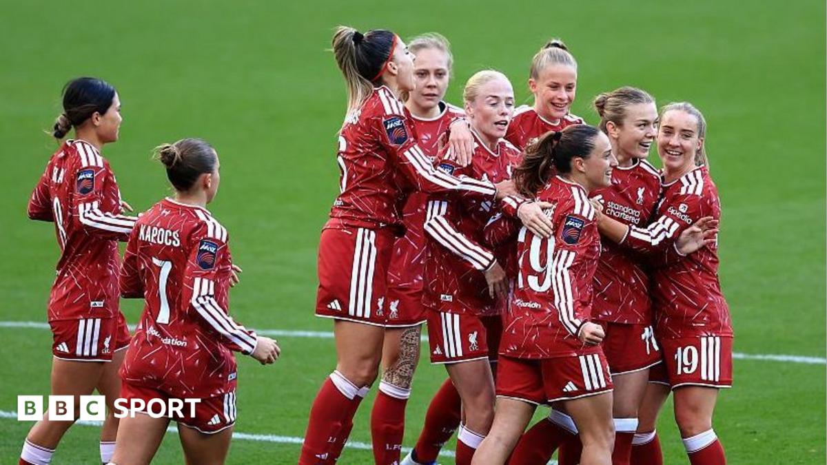 Liverpool players, wearing red, celebrate the opening goal