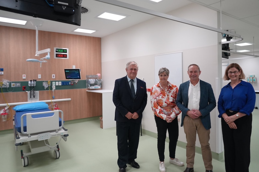 A group of four dignitaries inside a new hospital.