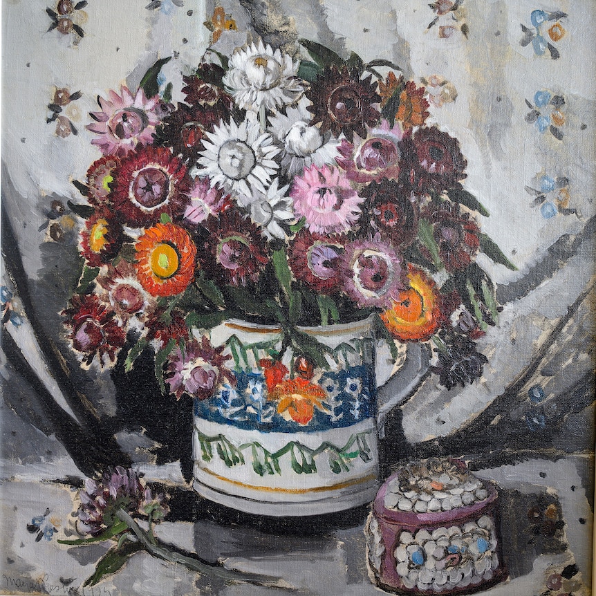 Painting of brightly coloured everlasting flowers in a vase on a table, a small heart-shaped box covered in shells next to it