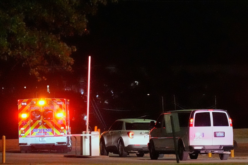 ambulances and vans with lights on