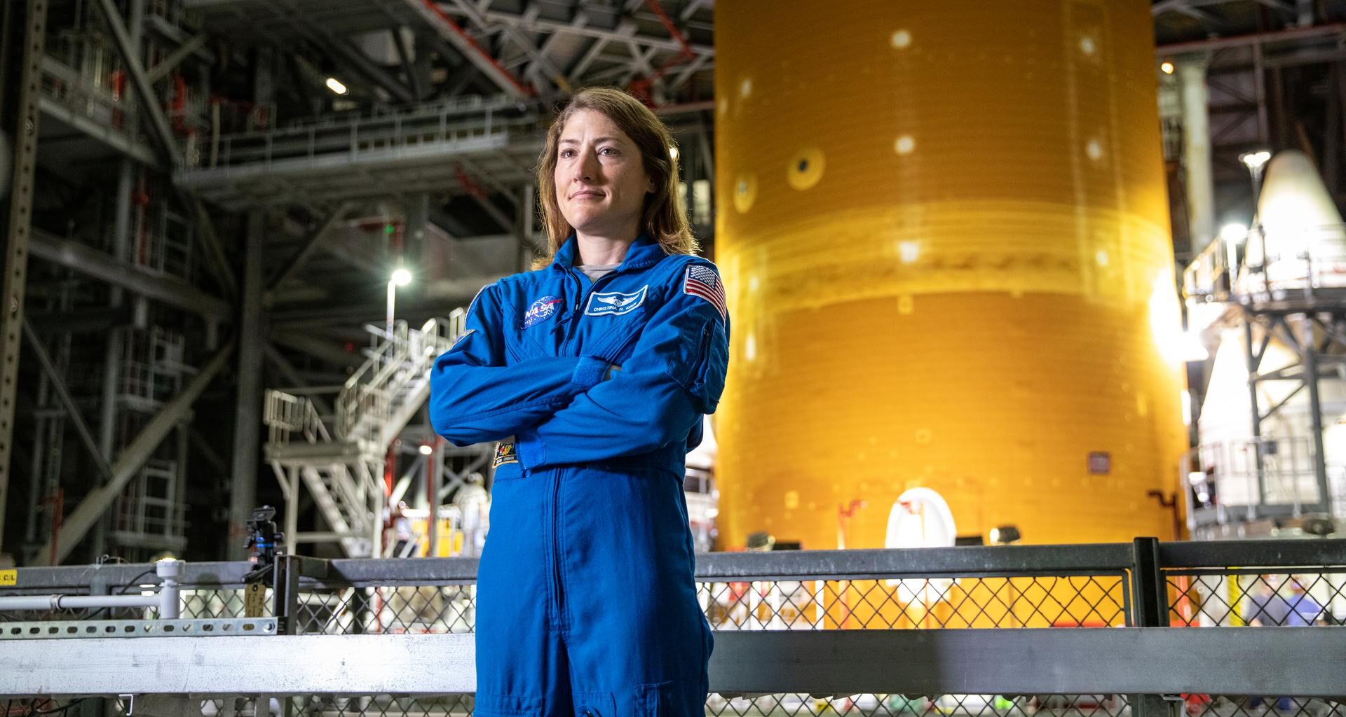 NASA astronaut Christina Koch stands inside Kennedy Space Center’s Vehicle Assembly Building on July 14, 2021, in front of the agency’s Space Launch System (SLS) rocket that ultimately powered the Orion spacecraft on the Artemis I mission. Koch later served as a crew member on the Artemis II mission in 2026, and on Oct. 13, 2026, NASA announced she will serve next as the agency’s acting deputy chief engineer.