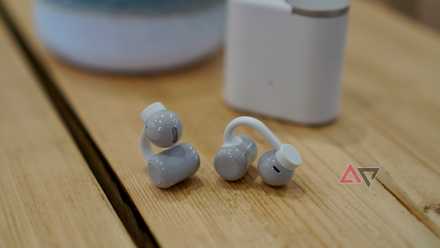 The CMF Clip Pro earbuds on a table