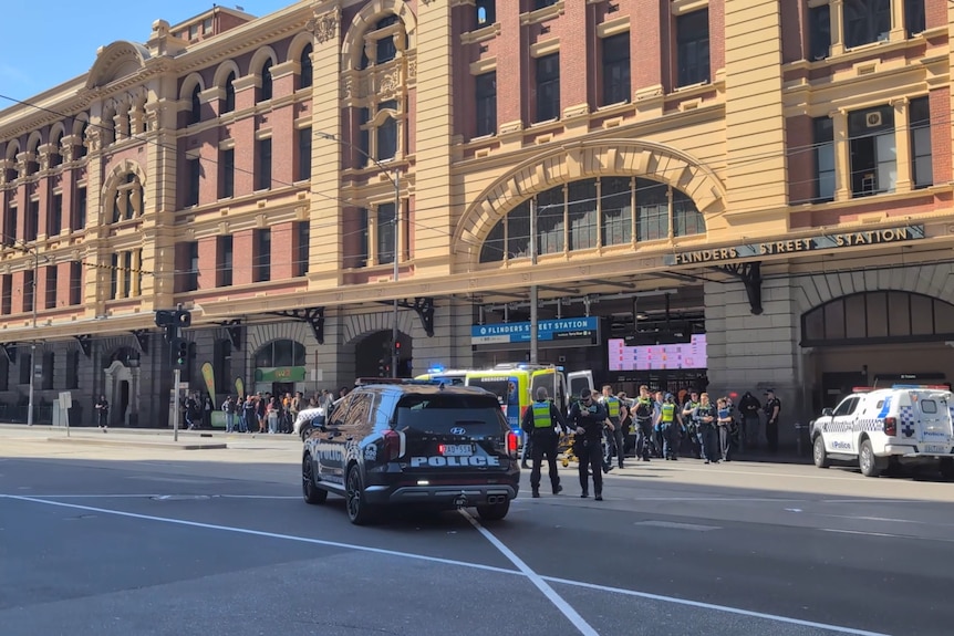 Multiple police cars and an ambulance visible at the Elizabeth street end of Flinders st station