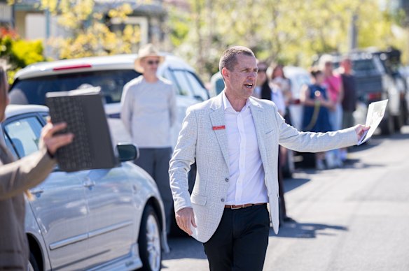 Auctioneer Tate Moore tracks the crowd as bids shoot up in $60,000 and $70,000 increments within minutes of the auction opening.