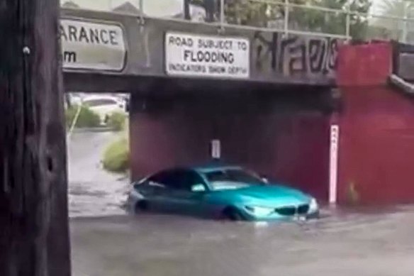 One of the cars caught in floodwaters beneath the York Street bridge in South Melbourne on Thursday afternoon. 