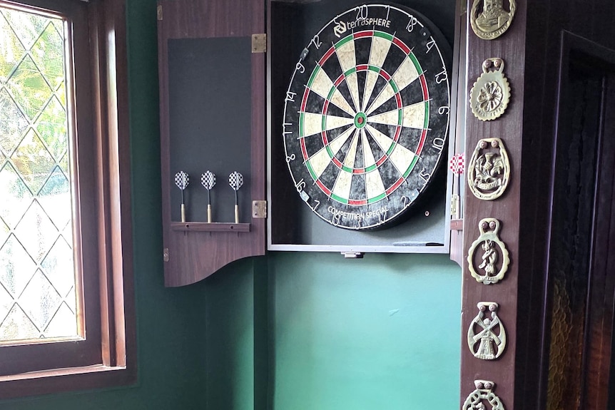 A dartboard and brass badges