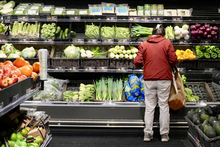 A woman shopping for fresh produce in a supermarket. 