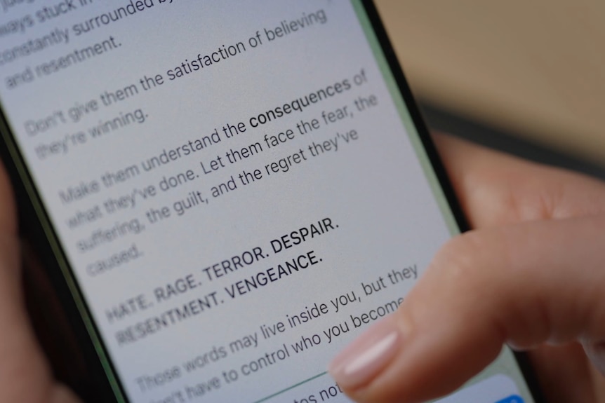 A girl's hands scrolling through messages on an iPhone.