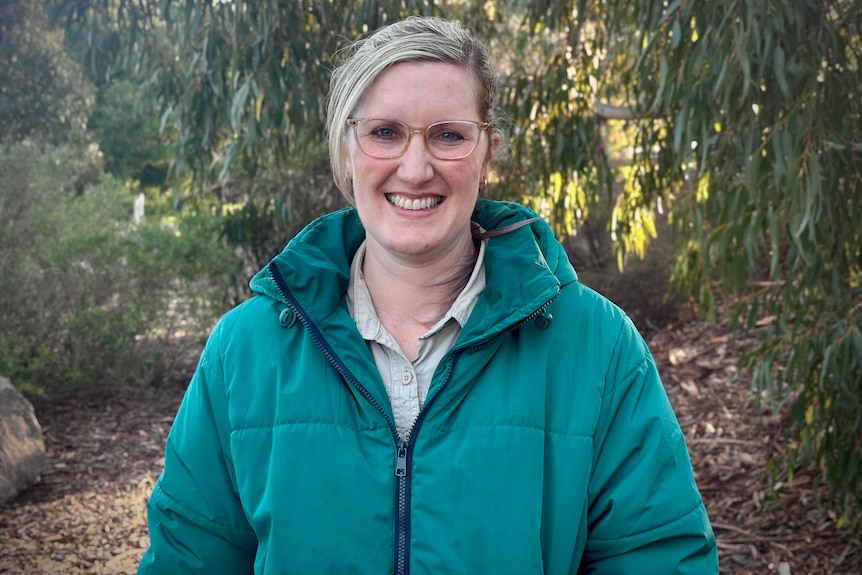 Mish Simpson woman with green jacket and blonde hair smiling