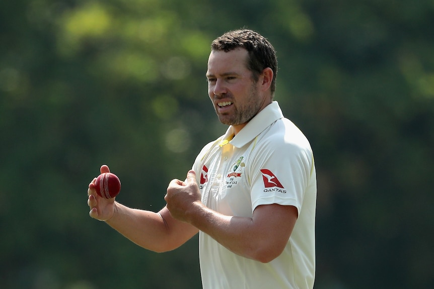 Jon Holland holds ball in right hand as he prepares to bowl