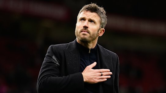 Michael Carrick reacts to supporters after his team lost.