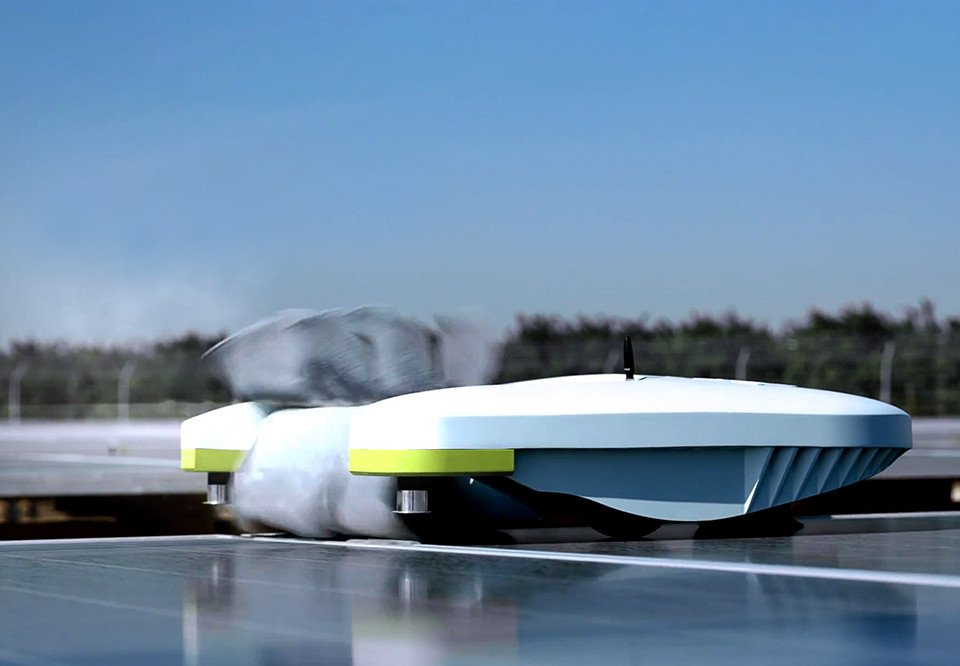 Ecoppia T4 cleaning robot on a row of solar panels