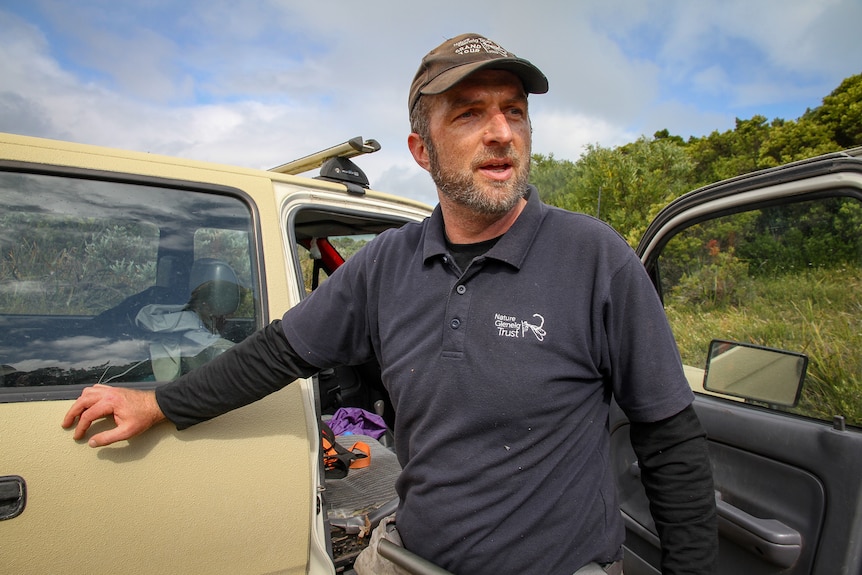 Mark Bachmann outside a car.
