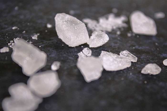 Crystals of amphetamine sit on a benchtop