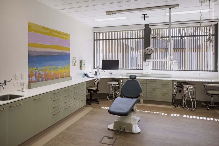 Generously proportioned treatment rooms feature warm finishes to soften the clinical space.