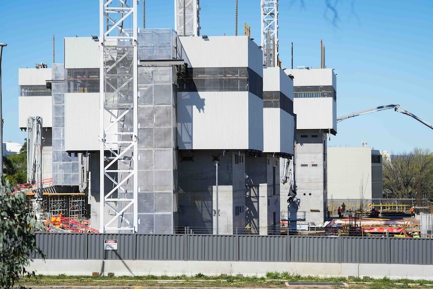 Workers constructing a large building.