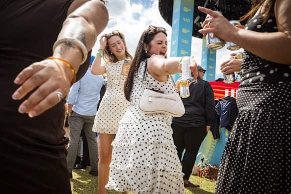 Chloe Condron dances with friends between races.