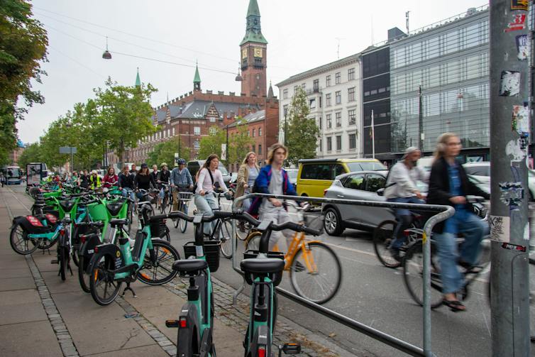 Cyclists and cars in the streets of Copenhagen, Denmark.