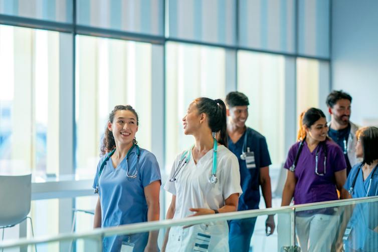A group of health-care professionals walking indoors