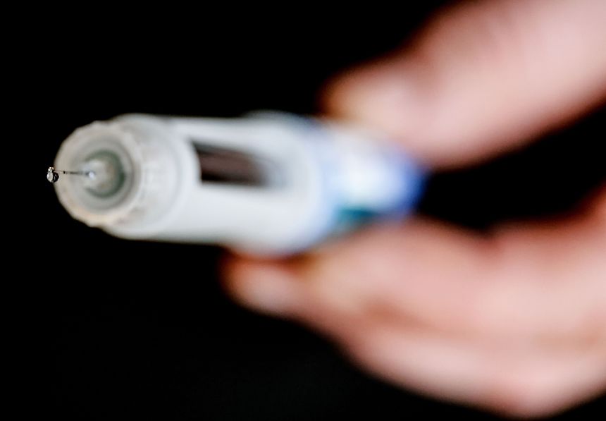 A man holds a syringe with the active ingredient semaglutide in his hand in January 2025, in Leverkusen, Germany.