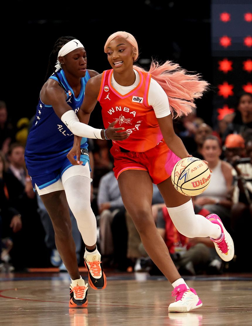 Reese dribbles against Rhyne Howard during the 2026 WNBA All-Star Game, this time with a pink wig installed by Brice.
