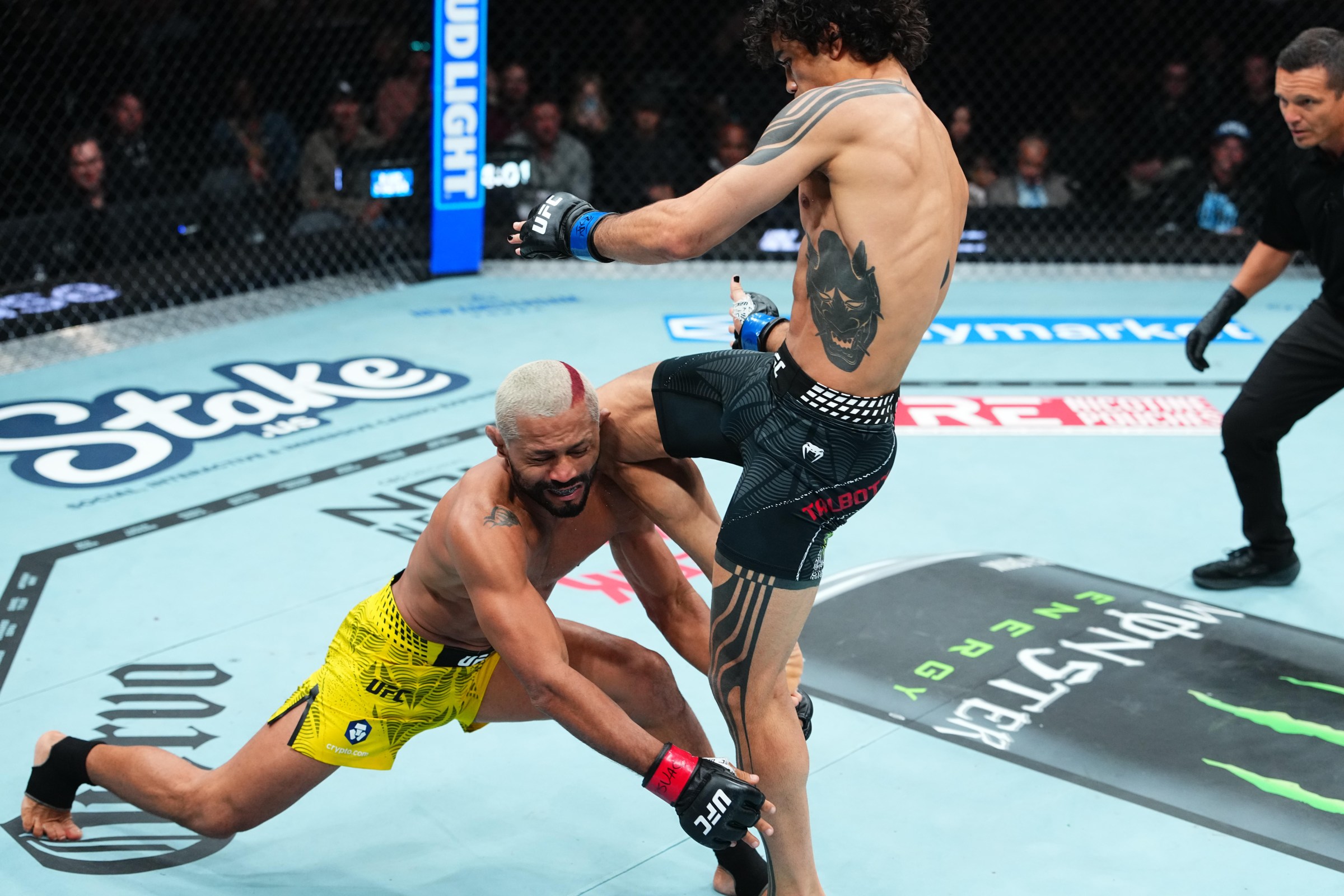 SALT LAKE CITY, UTAH - OCTOBER 03: Payton Talbott knees Deiveson Figueiredo of Brazil in a bantamweight fight during the UFC 332 event at Delta Center on October 03, 2026 in Salt Lake City, Utah. (Photo by Jeff Bottari/Zuffa LLC)
