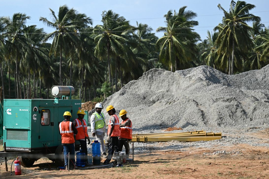 Workers stand at the Google AI and data center hub construction site in Rambilli, India, in September