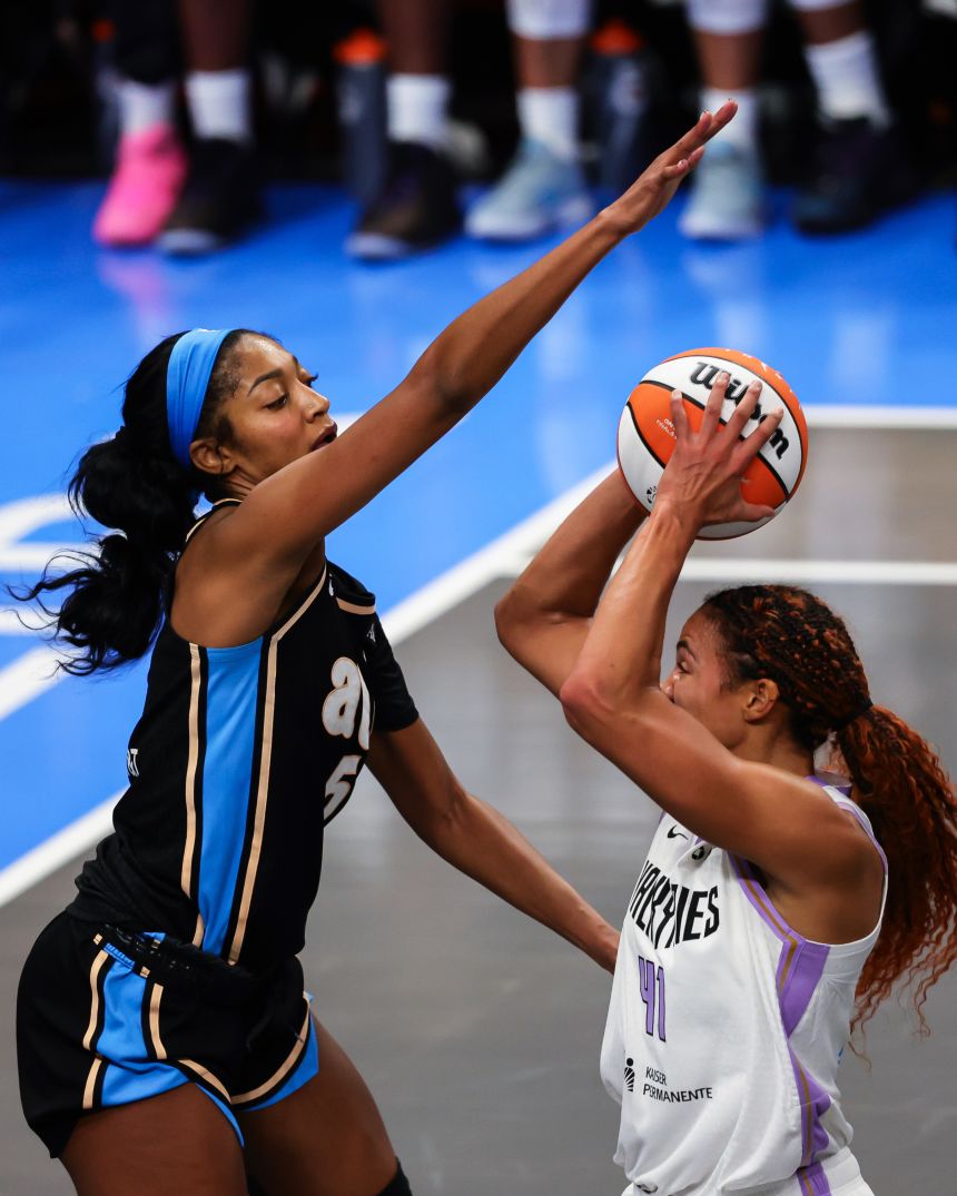 Reese defends against Golden State Valkyries' Kiah Stokes in Game 3, hair bouncing behind her.