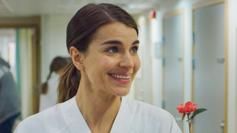 Johanne smiling in white nurse uniform in a hospital in 