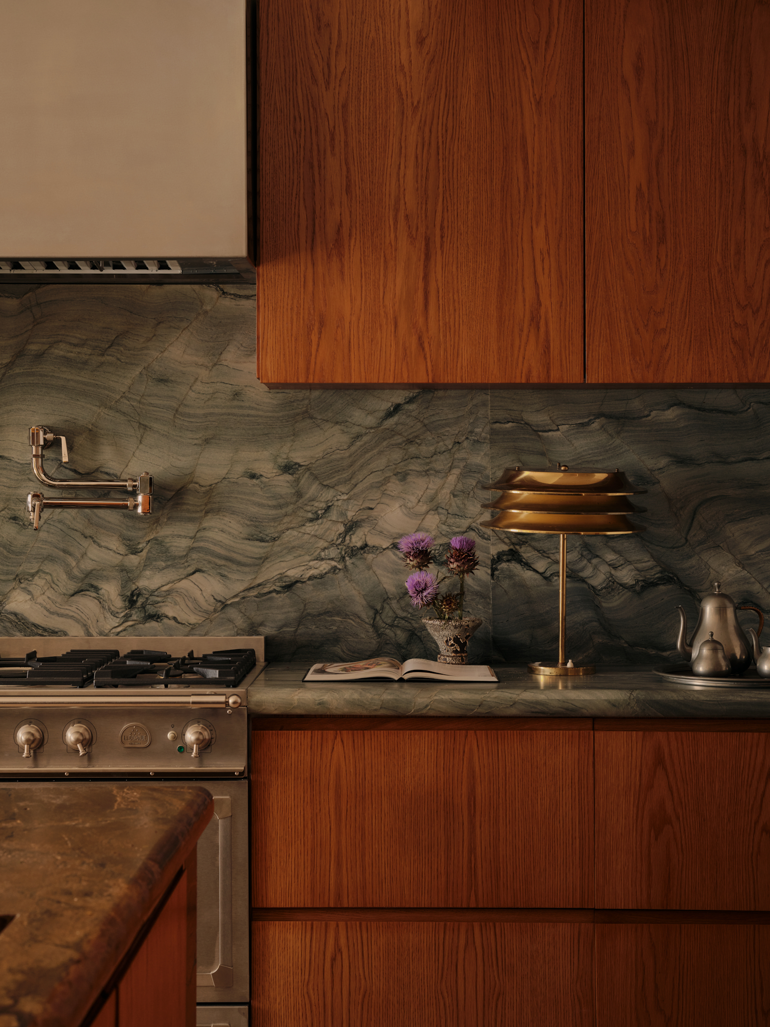 a dark wood kitchen with a blue marble backdrop