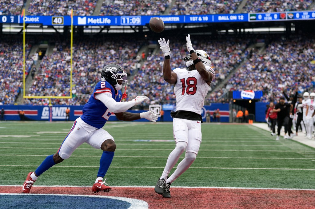 Arizona Cardinals wide receiver Marvin Harrison Jr. (18) reaches for a pass against New York Giants cornerback Deonte Banks (2) during an NFL game.