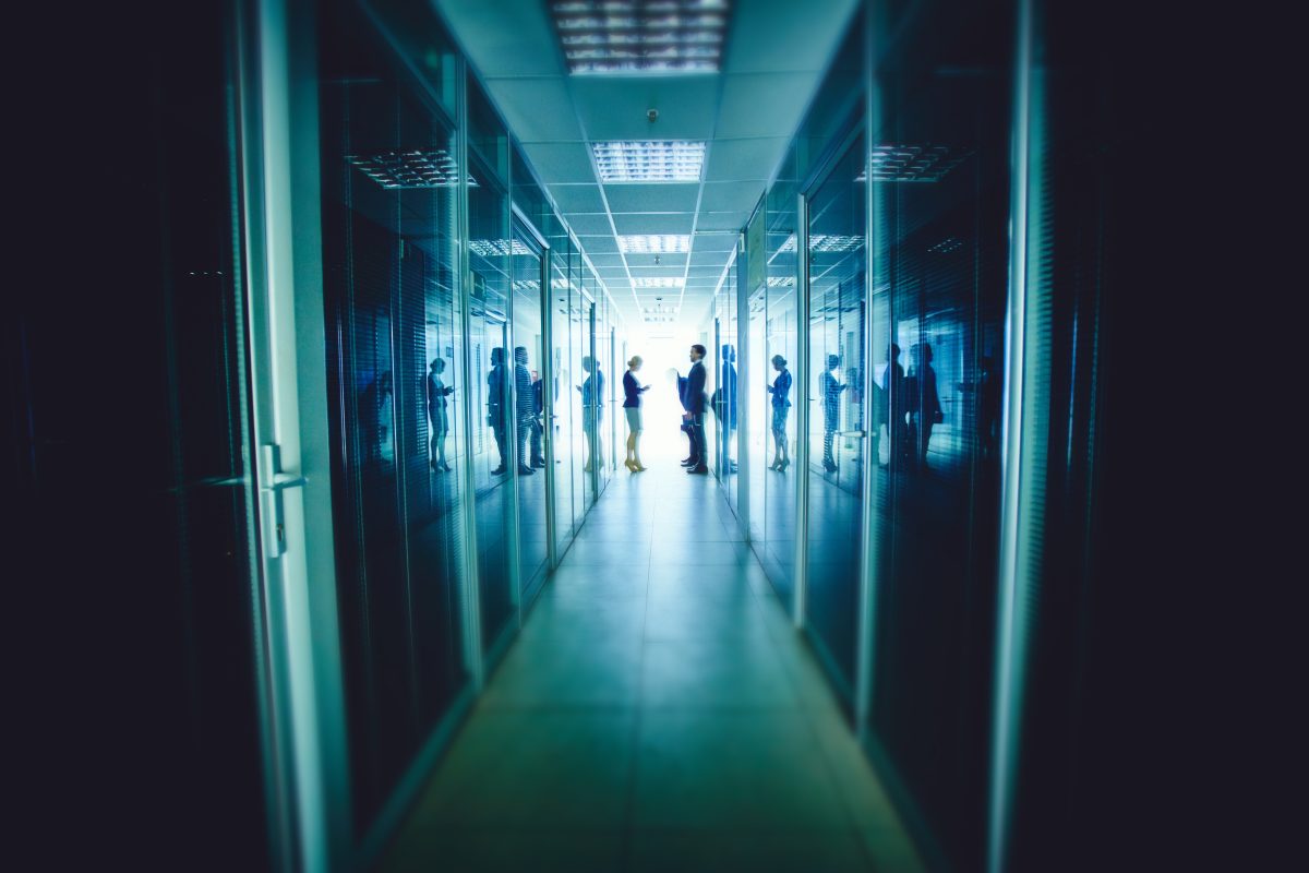 Business man and woman at the end of long corridor.