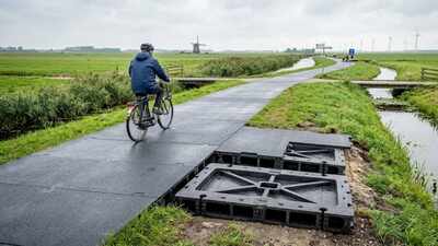 In 2018, Dutch engineers replaced a bike path with hollow panels made from recycled plastic; after 1 million crossings, the trial reported 50–70% lower carbon emissions, and rain storage reached 48% capacity