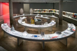 Curved display desks hold drawings, books and models from Devlin's career