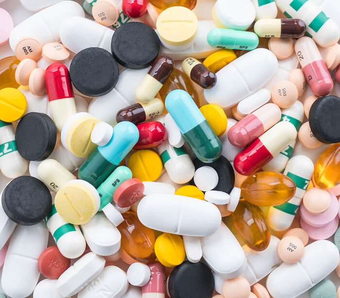 A colorful pile of various prescription pills and capsules from doctors.