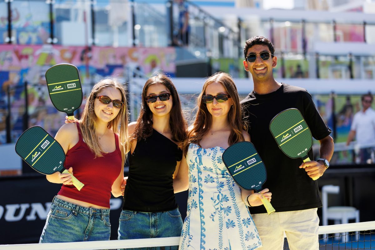 people holding pickleball racquets
