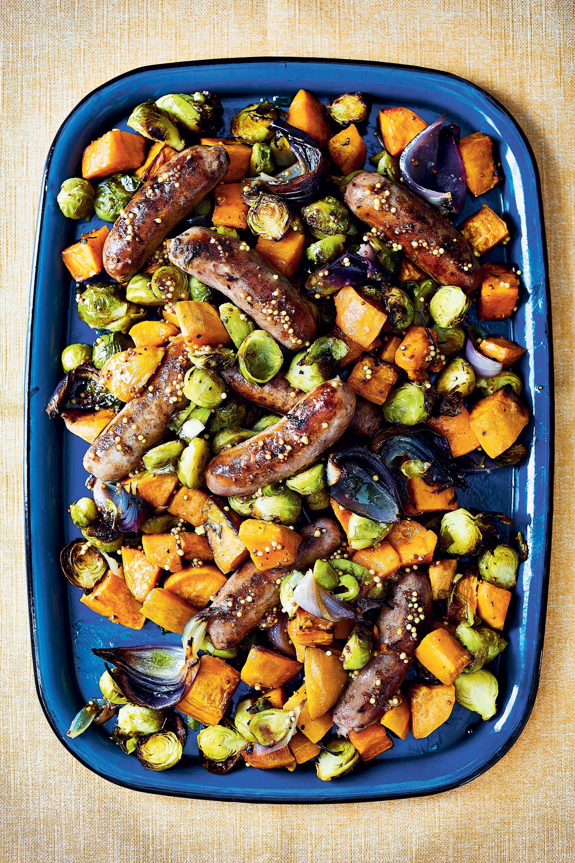 Brussels sprouts, red onion and sweet potato make this family traybake work harder than the average sausage supper