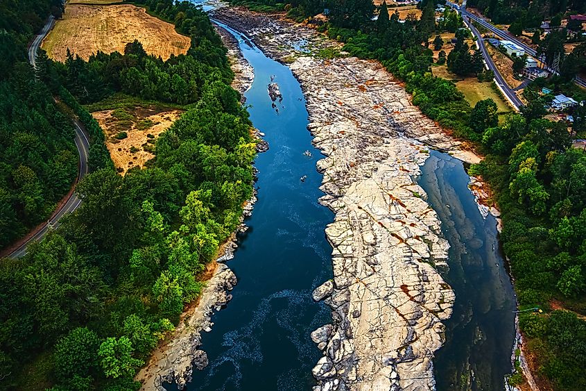 The Umpqua River flowing through forested hills at Elkton, Oregon