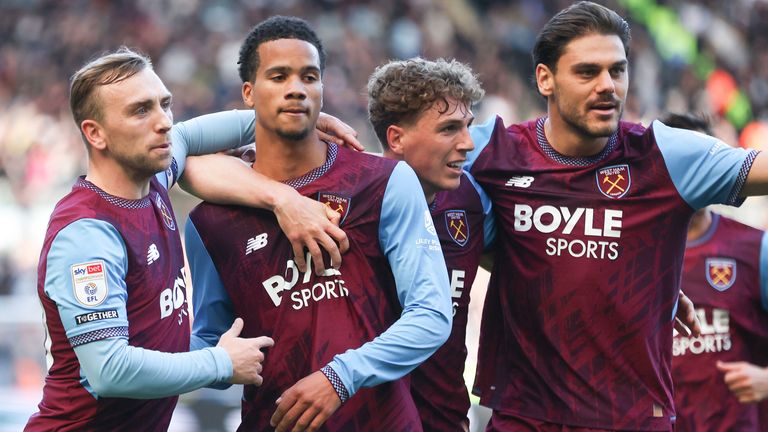 Divine Mukasa celebrates with his team-mates after giving West Ham the lead at Swansea