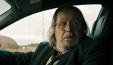 Sir Gary Oldman sitting in a car looking nervous in a production still from Slow Horses.