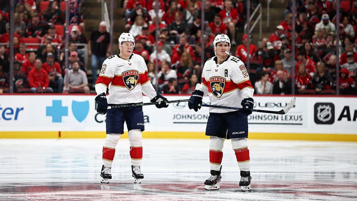 Matthew Tkachuk and Brady Tkachuk of the Florida Panthers skate during a hockey game.