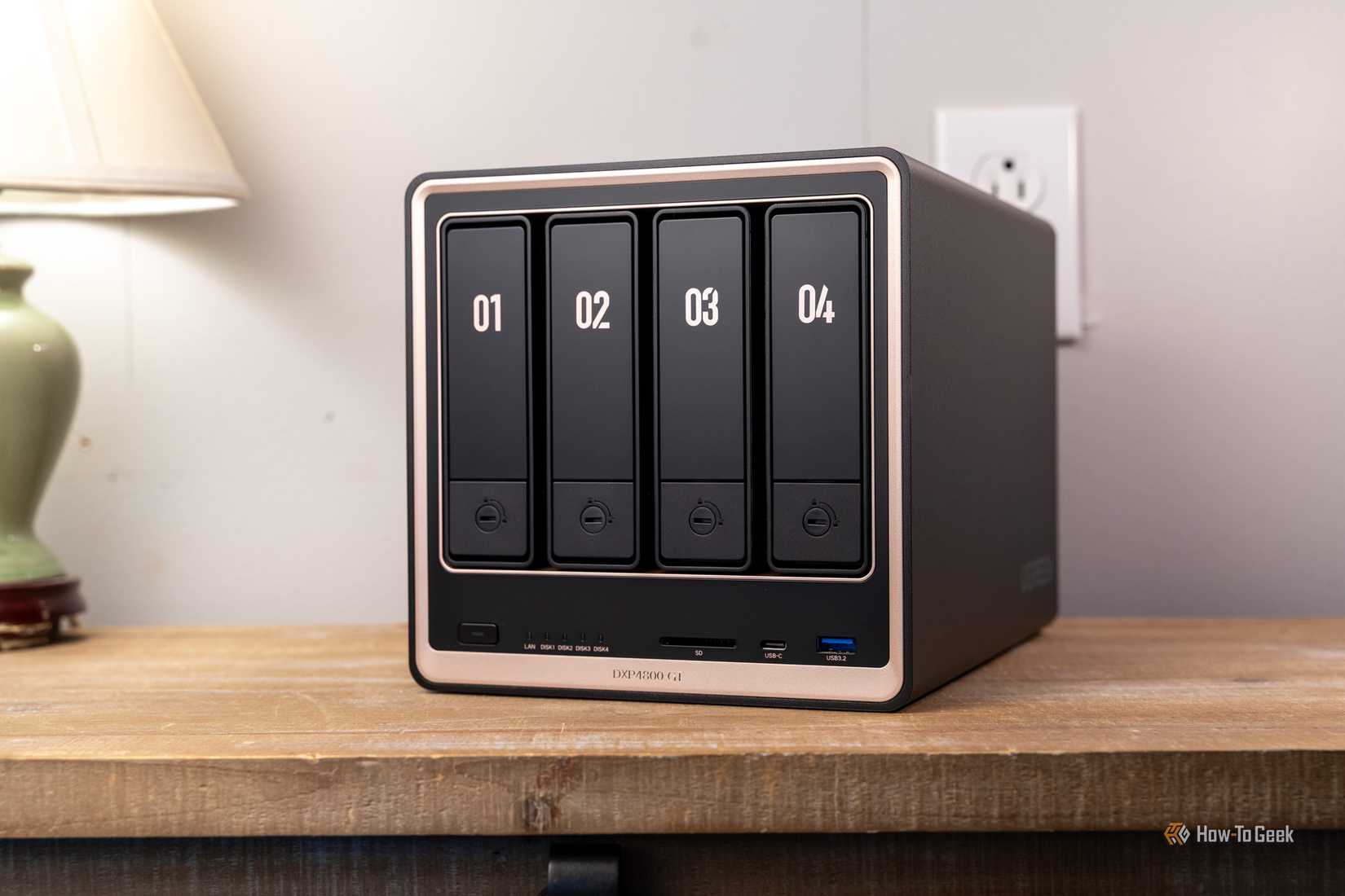 Ugreen DXP4800 GT four-bay NAS front view on desk.