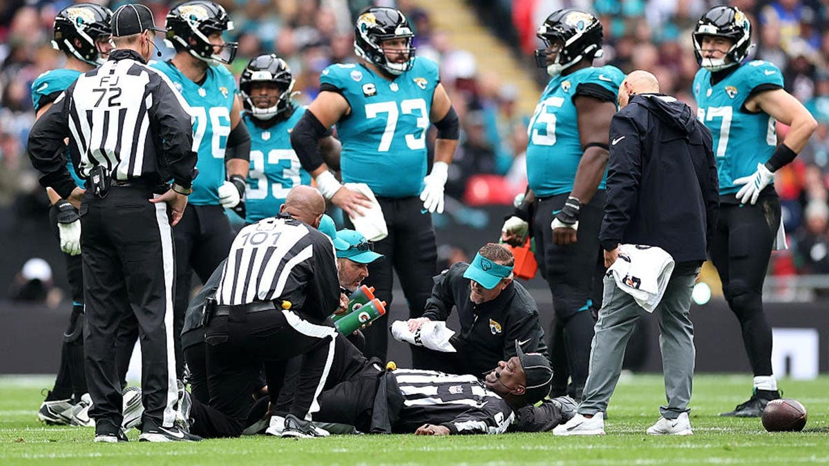 Umpire Larry Smith receives medical attention at Wembley Stadium.