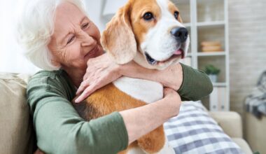 Smiling person holding a dog.