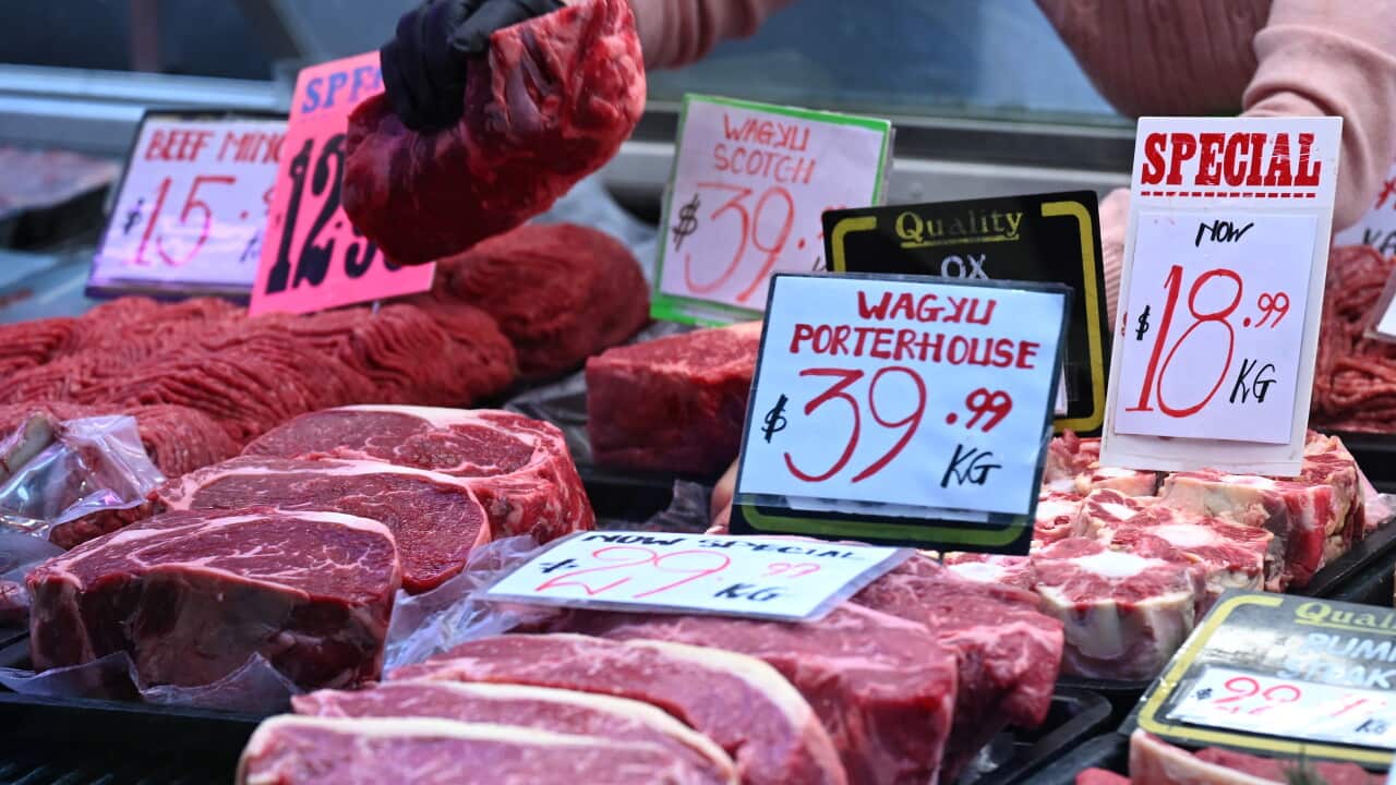 A close up shot of uncooked steaks at a market